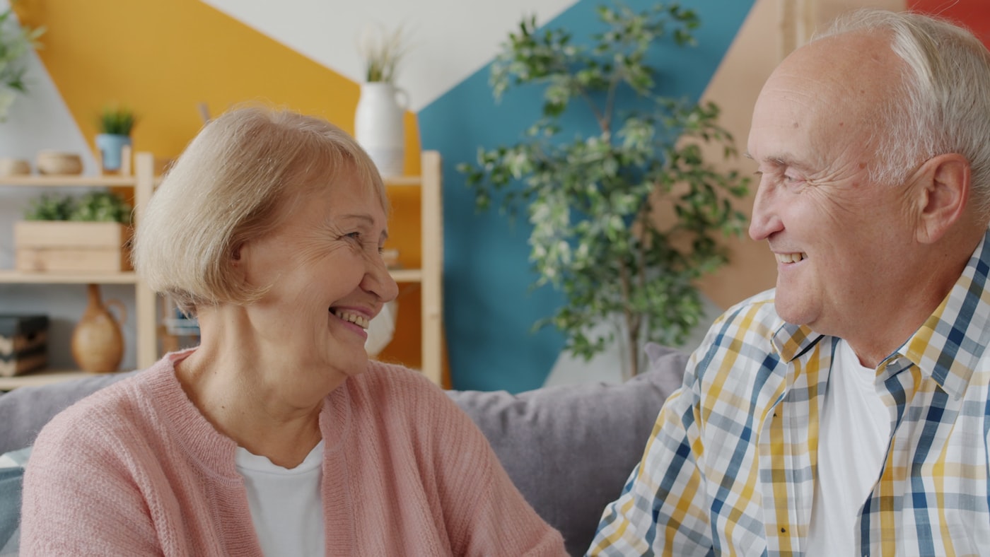 An older couple at ease, supported and confident in their care.