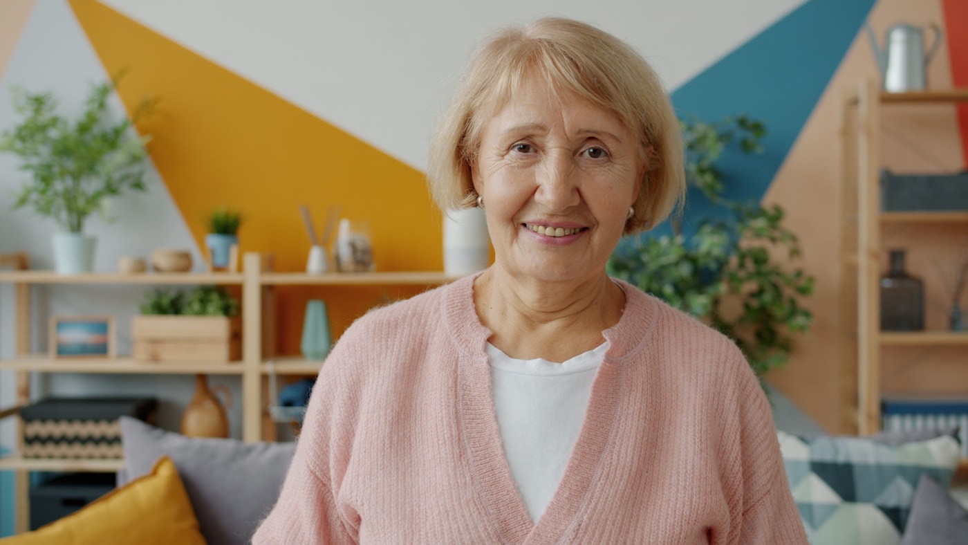 An older adult in a comfortable home environment, calm and at ease.