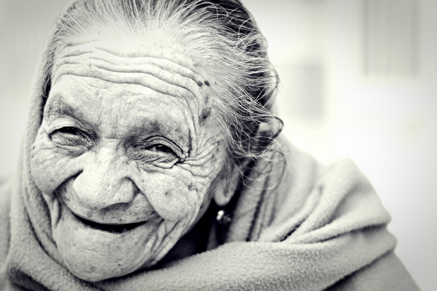 An older adult patient smiling during a positive health conversation.